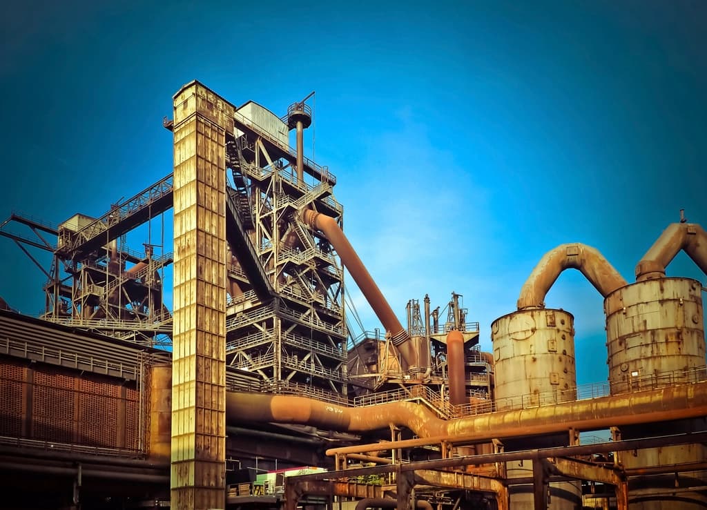 An industrial processing plant with pipework and stacks