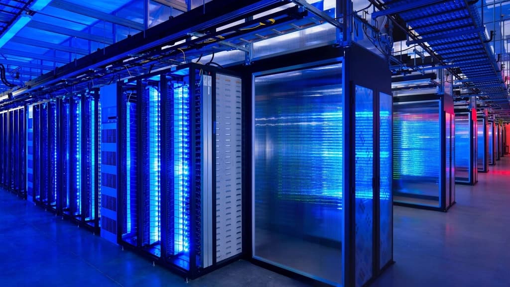 Server racks lit blue along a data-centre aisle